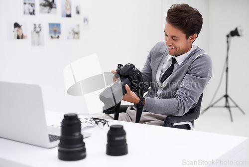 Image of Man, camera and photography in office with happy smile, checking image batch and creative in workplace. Person, thinking and glasses for vision, technology and editor in agency for digital photoshoot