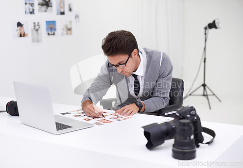 Image of Writing, photography and man in office editing with production, process and technology. Professional, editor and creative person working on desk with photoshoot results, review or notes for magazine