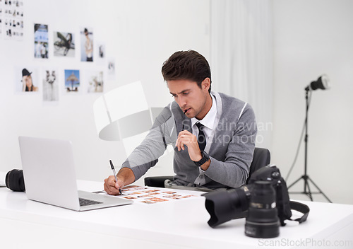 Image of Photographer, working and editing with computer in office with technology, software and thinking. Professional, editor and creative person learning on laptop with photoshoot results or cinematography