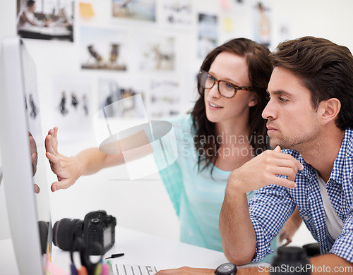 Image of Computer, office and photographers looking at photoshoot in a studio or workshop for production. Creative, photography and team of young artists with dslr equipment and desktop for picture inspection