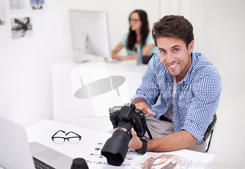 Image of Camera, portrait and photographer looking at photoshoot in a studio or workshop for production. Creative, smile and artist with dslr equipment for photography picture inspection in modern workplace.