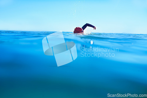 Image of Swimming, stroke and person in sea water in summer for exercise, training or workout on mockup space. Ocean, sport and a athlete crawl outdoor for fitness, health and triathlon competition in nature