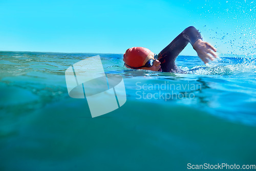 Image of Swimming, crawl and person in ocean water in summer for exercise, training or workout on mockup space. Sea, sport and a young athlete outdoor for fitness, health and triathlon competition in nature