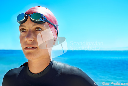 Image of Swimmer, water and woman at ocean outdoor in summer for exercise, training or workout on mockup space. Sea, sport athlete or person in goggles in nature for fitness, health or triathlon at the beach