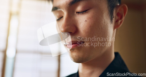 Image of Thinking, calm and young Asian man with meditation, zen and relaxing face expression at home. Idea, mindfulness and male person with memory, reflection and breathing exercise in modern apartment.