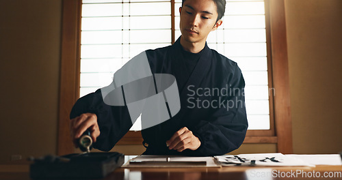 Image of Paper, ink and traditional Asian man for writing letters, notes and text for documents or script. Creative writer, culture and person with paint, tools and desk for art, calligraphy and handwriting