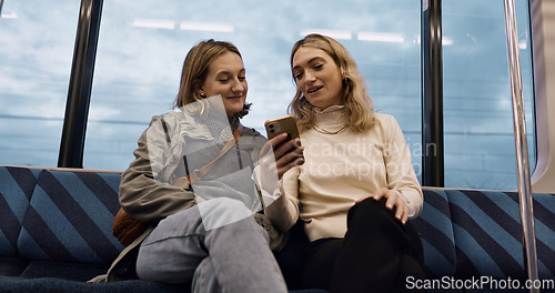 Image of Happy woman, friends and phone on train for social media, communication or networking in public transport. Female person or people talking with mobile smartphone for online search on railway ride