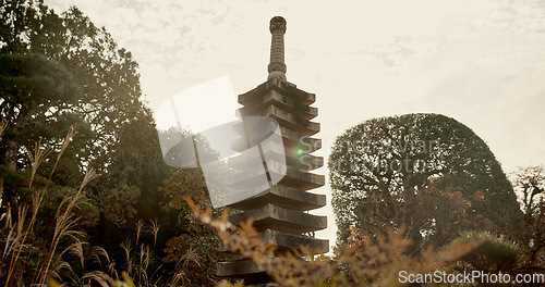 Image of Japanese temple, culture and sculpture in garden for zen, mindfulness or peace with trees in nature. Spiritual, Asian architecture and concrete structure with plants in forest or woods in morning