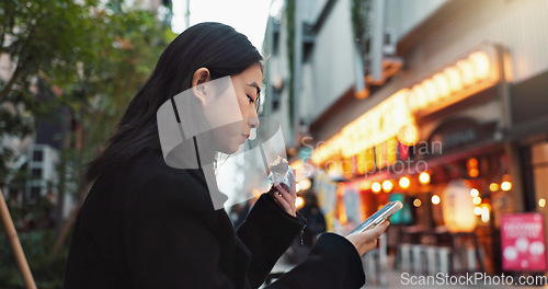 Image of Phone, eating and Asian woman with onigiri in the city on exploring vacation, adventure or holiday. Hungry, food and young female person enjoying a Japanese snack or meal in town on weekend trip.