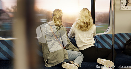 Image of Women, back view and train window with travel, journey with commute or tourism, transportation and sightseeing. Friends are together, traveller and adventure with trip, public transport and metro