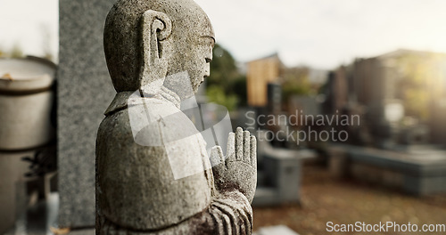 Image of Japan, prayer hands and buddhist stone statue at graveyard for spiritual religion in Tokyo. Jizo, cemetery and gravestone for memorial service, culture and traditional tombstone for worship or zen