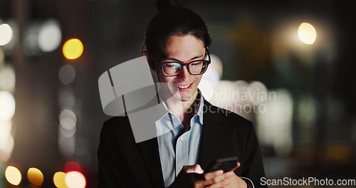 Image of Businessman, cellphone and typing in city at night for company travel opportunity, accomplishment or employment. Asian person, smile and texting in urban Japan as lawyer or communication for work