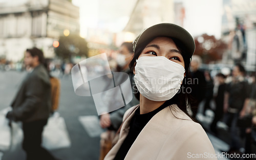 Image of City, japan and woman in travel with face mask for health and walking in town. Covid compliance, safety for wellness and female person outdoors with facial protection for corona virus pandemic