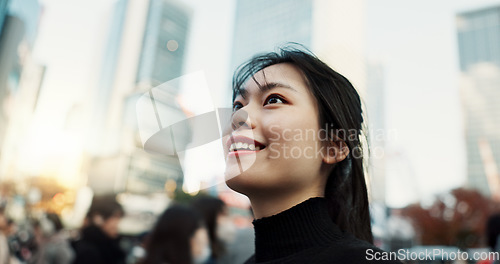 Image of Walking, smile and Japanese woman in the city for tourist sightseeing in the street on weekend trip. Happy, adventure and young female person commuting for travel in road of urban town in Kyoto Japan