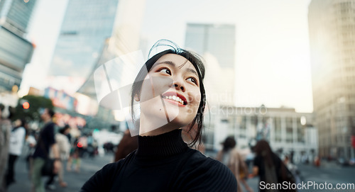 Image of Walking, happy and Japanese woman in the city for tourist sightseeing in the street on weekend trip. Smile, adventure and young female person commuting for travel in road of urban town in Kyoto Japan