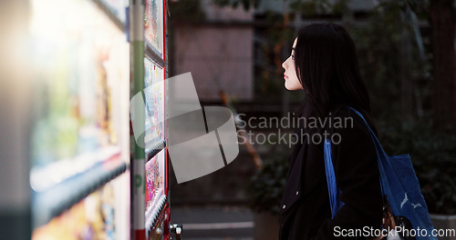 Image of Travel, food and hot drink vending machine with Japanese woman choosing snack to purchase in the dark. Night, hunger and choice with young tourist looking at product options for journey Tokyo city