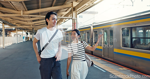 Image of Walking, conversation and young couple by train station for exploring on vacation or holiday. Travel, happy and Asian man and woman talking by public transport for adventure together on weekend trip.