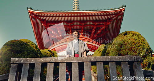 Image of Man, Japanese shinto temple and traditional clothes for culture, building or religion in sunshine. Person, ideas and vision for perspective with faith, mindfulness or thinking with low angle in Kyoto