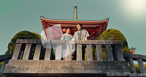 Image of Man, woman and shinto temple and traditional clothes for culture, building or religion in sunshine. Person, ideas and vision for reflection with faith, mindfulness or buddhism with low angle in Japan