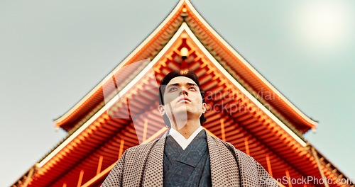 Image of Asian, man at temple in Japan and religion, low angle view for mindfulness, culture and tradition. Worship, peace and walking in traditional clothes outdoor with Japanese architecture and landmark