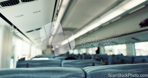 Image of Empty train interior, seats and transport with moving, window and vehicle with public infrastructure. Locomotive, railway travel and chair for passenger commute, services and carriage in Tokyo