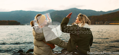 Image of Women friends, hug and back at beach with care, love and outdoor with high five, support or celebration on travel. Girl, cheers and achievement with boat, water or lake with bonding by river in Japan