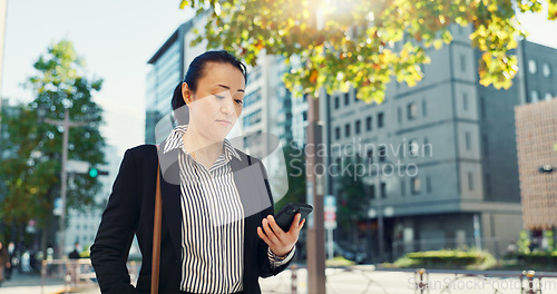 Image of Cellphone, walking and business woman in the city networking on social media, mobile app or internet. Technology, street and professional Asian female person with phone commuting in street in town.