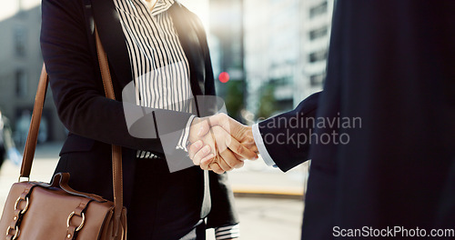 Image of Business people, handshake and city for greeting, partnership or agreement in outdoor deal or meeting. Closeup of employees shaking hands outside for b2b, teamwork or hiring in an urban town together