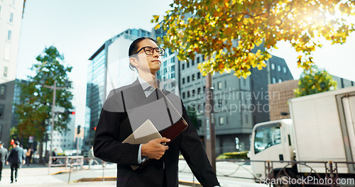 Image of Walking, city and Asian business man with tablet, documents and file for morning commute in urban town. Professional, corporate worker and person thinking on travel for career, work and job in Japan