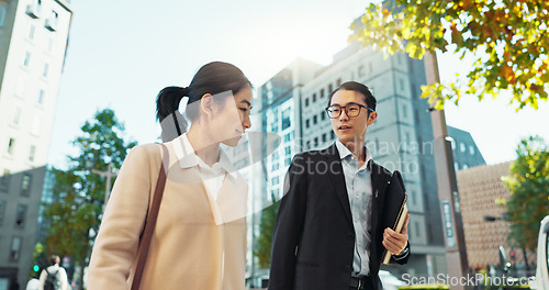 Image of Walking, conversation and business people in the city talking for communication or bonding. Smile, discussion and professional Asian colleagues speaking and laughing together commuting in town.