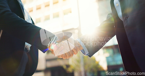 Image of Business people, handshake and city for partnership, agreement or greeting in outdoor deal or meeting. Closeup of employees shaking hands outside for b2b, teamwork or hiring in an urban town together