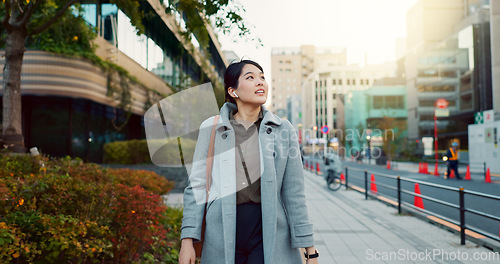 Image of Woman, Asian and walking, travel or commute to work with professional in city with earphones. Listening to music on journey, podcast and commuter on urban street or sidewalk in Tokyo with playlist