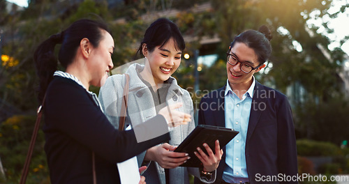 Image of Tablet, discussion and business people in the city talking for communication or bonding. Smile, conversation and professional Asian colleagues speaking with digital technology in urban town.