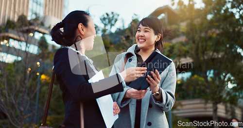 Image of Asian woman, tablet and team in city of Japan for communication, research or social media together. Business people smile on technology for online search, chat or networking on sidewalk in urban town