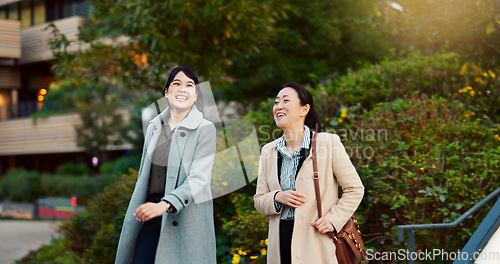 Image of Walking, conversation and business women in the city talking for communication or bonding. Smile, discussion and professional Asian female people speaking and laughing together commuting in town.