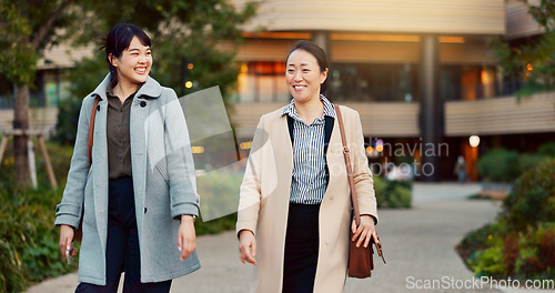 Image of Walking, conversation and business women in the city talking for communication or bonding. Smile, discussion and professional Asian female people speaking and laughing together commuting in town.