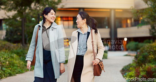 Image of Walking, conversation and business women in the city talking for communication or bonding. Smile, discussion and professional Asian female people speaking and laughing together commuting in town.