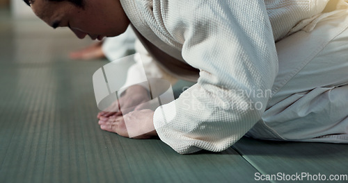 Image of Asian man, student or bow in dojo for respect, greeting or honor to master at indoor gym. Closeup of male person or karate trainer bowing for etiquette, attitude or commitment in martial arts class