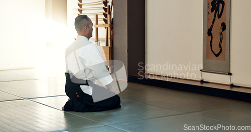 Image of Asian man, sensei and bow in dojo for honor, greeting or respect to master at indoor gym. Male person or karate trainer bowing in class for etiquette, attitude or commitment in martial arts on floor