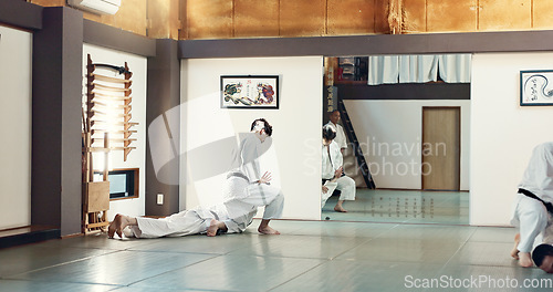 Image of Students, karate or people learning in dojo for fitness, martial arts discipline or self defense combat. Demonstration, workout or kung fu master training athletes for fighting, education or class