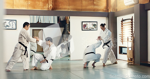 Image of Students, karate or people learning in dojo for fitness, martial arts discipline or self defense combat. Demonstration, workout or kung fu master training athletes for fighting, education or class