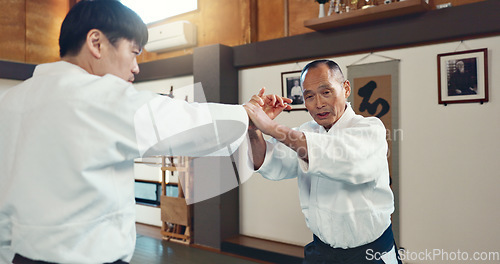 Image of Aikido, sports and martial arts training class with students and sensei, self defense and discipline. Fitness, fight and education, black belt with Japanese people and workout for exercise in dojo.