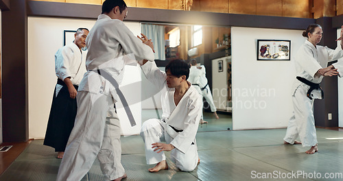 Image of Martial arts, sensei and Japanese students with training, fitness and action in class for defence or technique. Aikido, people or fighting with discipline, uniform or confidence for culture and skill