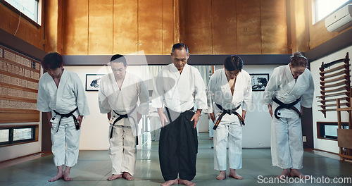 Image of Martial arts group, men and bow at training, respect or honor for fight, conflict or competition in dojo. Senior sensei, Japanese students and together for aikido with exercise, workout or discipline