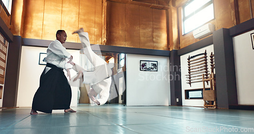 Image of Aikido, fight and sensei master in martial arts with training of student in self defence or discipline. Class, demonstration and Japanese man with black belt in fighting for education of skill