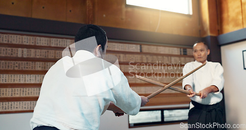 Image of Asian man, taekwondo and training with wooden sticks for martial arts, fighting or sparring partner in dojo. People in fight practice with dummy weapon to opponent in karate for self defense at gym