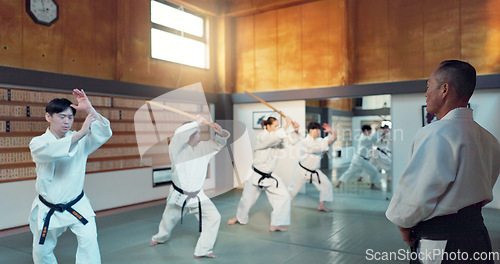 Image of Martial arts people, aikido class and sensei teaching protection, self defense or combat technique. Black belt students, education and Japanese group learning, skill development and practice in dojo