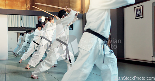 Image of Martial arts, aikido class and people with training discipline, self defense and practice sword technique. Black belt students, Japanese group and learning skills development for protection in dojo