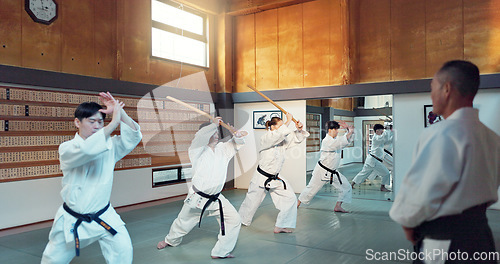 Image of Martial arts people, aikido class and sensei teaching protection, self defense or combat technique. Black belt students, education and Japanese group learning, skill development and practice in dojo