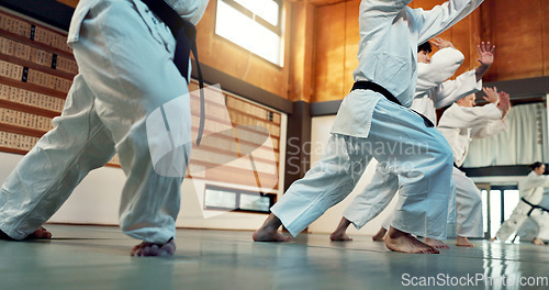 Image of Students, Japanese people in aikido class for fitness and martial arts training class with self defense and discipline. Combat, fight and education, black belt with workout for exercise in dojo